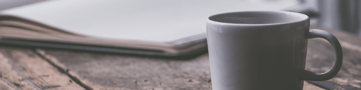Book and coffee mug on a table